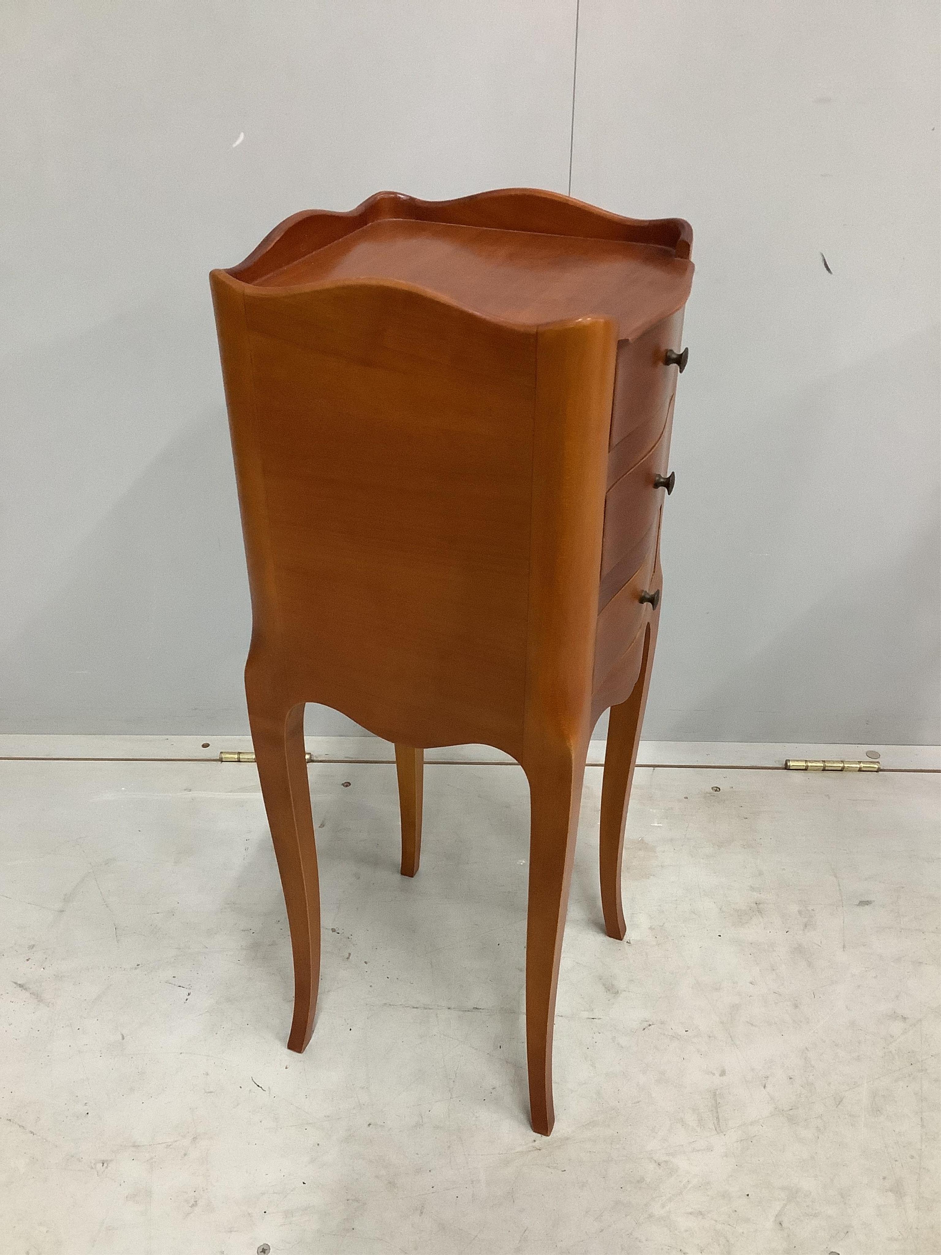 A pair of French cherry three drawer bedside chests, width 24cm, depth 26cm, height 70cm. Condition - fair to good